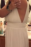 Purchased this dress for a destination wedding (the wedding was canceled due to COVID so I don't have any wedding pictures). The dress was beautiful, very low cut so would definitely need to add cups and maybe some sort of closure to keep from spilling out. The open back was unique and pretty and the cut around the armpit is very deep as well, but if cups are added to the bust and/or tape is used it shouldn't be an issue. Very, very long but I am super short so I had figured it would need to have it hemmed. - Ilissa F.
