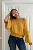 Got like 5 compliments on this shirt today and it is only noon!! I am normally a medium but read the reviews and ordered a small. The small fits PERFECT! So I would size down. The color is so beautiful and the elastic at the top is thick and it actually stays around my shoulder for the most part. Got this on sale as well. Great buy!! Love it! - Christen A.