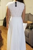 It's a beautiful dress, but not what I was looking for. The skirt is amazing and a nice fabric and weight. I wish the top had boning to keep its shape and make it seem higher end, but if you've got a larger chest it wouldn't matter as much. The pinkish lining under the lace didn't compliment my skin tone and I was hoping for a higher neckline, which contributed to why I returned it in the end. - Angela M.