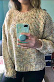 Soft and warm, it is a loose-knit though so if you're wearing a dark-colored bra you can tell. It's not terribly obvious but I noticed my blank tank showing through. Took two photos, the lighter one is natural lighting, but it looks a little more like the darker pic in person. The mustard yellow threads are more pronounced than it seems. More colorful than I expected but not in a loud way. Comes down just over the top low rise jeans on me. Also, it did shrink a bit after I washed it so I recommend air drying it. All in all this sweater will be a new winter staple for me  :) - Stephanie C.