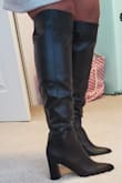 Been looking for knee high boot since last fall. Glad I waited because this boot rivals higher priced brands. Love the fit, style. Looks great with jeans, leggings skirts or dresses. The circumference is more than sufficient for my calves (mine 15.5" round). I'm 5'10 and the boots hit at top of my knee. I push the boots below my knee. Can feel awkward at bend in knees but not a deal-breaker for me. I would not recommend this boot for petite person or smaller calf. I'm definitely not disappointed and would recommend to anyone who's been searching high and low for a tall boot. Plus it's wide calf friendly without being wide calf. - Maria T.