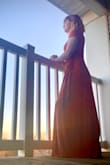 This dress brushes the floor with me but it's fine with flat shoes. The dress has a hole to pull the waist ties through which makes it very easy to adjust. The material is thick which is nice for the fall months. Very soft and stretchy. - Katie B.