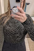 This bodysuit is SO cute! I am 5'9," and it is long enough for my torso; I have difficulty finding any bodysuit/jumper that works. The material is comfortable and has a decent stretch to it. I was also pleased to see that the sleeves are long enough for me because I have pretty long arms. It's fitted for my body type, but I think even if I were to lose 10lbs, it would still fit snuggly because of the material. Also, I thought it would be see-through because of the mess; it is not! Which is fantastic because I am not that bold! My only complaint is the snaps are a bit bulky on the bottom, but if you were underwear with it, you don't feel it. It's also not a full coverage bottom, so be aware that it's more thong style. I would recommend it! - Ashley H.