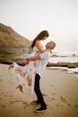 This dress is absolutely gorgeous and a dream to wear for our engagement photoshoot. Love the pattern, the flow, and the slit down the front! I had it tailored to be shortened by about an inch and also had bra pads placed in. - Hannah H.