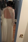I ordered this dress to try on as a potential wedding dress. I'm typically a large, size 10 in most clothing. I ordered both a M and a L in this dress, and I actually prefer the large. I have slightly broad shoulders, so the large gave me more room to move my arms around. The medium was also a little tight around my rib cage, although I could zip it. The sleeves were baggy on both dresses and would need to be taken in. I would also need to have several inches hemmed off the bottom. Im not crazy about the fit of the top (its a little frumpy on me as is). But I think with the right bra and some neckline alteration, this could be a very flattering dress. The quality of the material is very thick and comfortable. It seems durable and would hold up to a night of dancing. Overall, a great wedding dress contender! - Erin T.