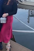 This skirt is a pretty color red, and as a nice shape to it. It works well with the Lulus black, long sleeved sweater with an open back, and Lulus fun, bling sandals. - Melanie D.