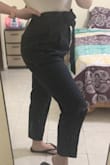 I was excited to see these pants were back in stock, since I need to wear navy pants for work. Over the summer I purchased the "Set Your Goals Navy Blue Paper Bag Waist Pants" and they are fine, not the best quality but at least they stretch and are flattering. When I received these, the quality of the fabric was better, as expected, but the fit is off. First, although the fabric is better, I can tell it won't be breathable. I live in a hot climate so that's a must. The crotch was also about an inch below where it should be (when the waist was at my natural waist) and I wonder if it could cause chaffing. So I pulled the waist up but then it's ridiculously high! (see first photo). With a bit of a pooch, that does not look flattering on me. I also noticed that the pleats just make my belly look even bigger the way they puff out. Oh well. I'll be returning this one. - Kara G.