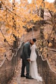 I ordered this dress online off of whim because it looked really nice, was very affordable and if I didn't like it- I could easily return it back. As I tried on the dress, it was absolutely perfect and I realized the style matched perfectly for my outdoor, whimsical, November wedding.
I did have a few alterations to have my dress fit like a glove: tightened the shoulder areas by about 1.5 inches, trimmed the bottom-front by 2-3 inches (my heels were only 2.5 inches tall), and added a wrist loop to hold the train up when I danced around all night at reception!
Overall the dress+alterations totaled about $250 which is still a real bargain for a wedding dress!! - Ana R.