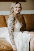 I wore this dress for my small outdoor covid wedding and it is such a stunner! The beading detail on the bodice is so beautiful. It also has built in bra cups which was really nice since my boobs aren't the biggest so I didn't need any additional bra/tape. I got so many compliments on this dress and I felt so beautiful. The pictures do not do it justice! I highly recommend this dress!! - Shaina W.