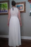 This dress fit perfectly and was very comfortable. It was slightly too long. If I had decided to keep it, I would have gotten it hemmed. I really liked it but since I bought many dresses I needed it narrow them down. I decided to eliminate this one cause I thought it made me look wide from the front pictures. Loved how the back looked! - Kimberly H.