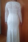 The material is very flexible and light weight. It is very soft and easy to move around even with the sleeves. The pictures on the model make the dress look like it is a cream or light tan but the dress I received was a nice bright white.  If you are looking for a dress with sleeves, I'd highly recommend this one. The length was also perfect! - Kimberly H.