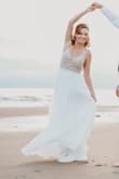 I had originally bought a different dress in a boutique but my mind kept straying back to this dress. When we changed our venue to the beach, I decided to order it. I'm SO glad i did! It is absolutely beautiful and well well worth the price! I ordered a 2 and it fit a little big on the top, I wish I would have ordered a 0, but it photographed fine. The back is gorgeous and the bead detail is just beautiful. Absolutely love this dress! If you're contemplating it, buy it!!!! - Lacey D.