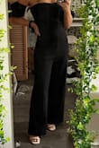 I'm super petite and I always assume I'm going to have to alter whatever long-pants item I order online. I purchased in an XS & it fit nearly perfect! While the legs did run a couple of inches longer than I would've wanted them to, it's basically close to perfect & I honestly was expecting it to drag onto the floor due to how short I am, but with heels it's almost perfect! I love the puffed sleeves and the ruched top - it adds a little sass to the plain black. I plan on wearing this to a wedding & I can't wait to wear it for other occasions! - Jacqueline B.