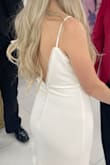 I wore this dress for my small wedding elopement. The design is beautiful! The dress fit well, but was not the most flattering. The material is heavy but somewhat thinner than I expected. If you are wanting to wear any undergarments AT ALL (including Spanx) you will be able to see it through the dress. The fabric doesn't hide any unwanted lines, so if you're wanting something more forgiving this may not be the right fit. - Allison C.