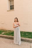 I wore the dress for my 21st and adore it. Customer service was excellent, my dress was backordered so I was afraid it wouldn't come in time even with speed shipping, but they got it to me early after I told them my concerns. It's true to color, I personally love how silver it looks. It was super long as most long dresses from Lulu's are. My mom hemmed it to be about 4-5 inches shorter so I could wear it with heels and not have it drag on the floor. The bust area exposes it bit too much and I could see my bra in many pictures, but that may just be because of my nonexistent chest. Outside those two minor issues, I love the dress and would definitely recommend it! - Megan N.