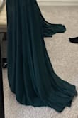 This dress fits very well, with the exception of the length. I'm 5'1 and will definitely have to get it hemmed as you can see from the pictures. It is also made for smaller busted women, there is more side boob than I'd like but my friend said we can tape them together to get rid of the side boob. It really is that pretty that I'm willing to make it work. The green is a beautiful deep color too. - Ty G.