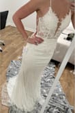 I ordered this dress as a wedding dress option. Dress has beautiful floral embroidery. Low back with hidden zipper/clasp. The Cris-cross ties are like a satin material. I have a small chest/cup size and the top of the dress still fits good, not a lot of gaps. There is a train to this dress. Very elegant feel. There is a sheer piece that covers the deep V in the front of the dress. Material is comfy to wear and you can move around in the dress just fine. Only downfall, the glitter that is on the outside layer of the dress. The dress is two layers.
I have an athletic build, wider hips and a booty. 135-140 Lbs and the size 4 fit perfect. - Tabitha E.