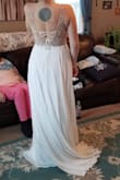 This dress to the most flattering dress I have tried on throughout this entire process.  It falls nicely in all the right places.  The bead work is amazing and beautiful.  The quality of this dress is even better than similar versions I tried on in bridal shops, at much higher price tags.  This dress was not the style I was going for for my snowy, wintery wedding but am so very tempted to shift my idea.  It fit like a glove.  I was torn between a size 6 or 8, and decided to go with the 6.  It fit perfect. Is comfortable to move and sit in as well.  Do not hesitate if you are considering this dress. - Sarah D.