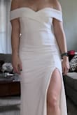 I ordered this for my small wedding ceremony so I could save my actual dress for our big wedding. I ordered both a large and a medium to see what fit best. The medium was a little tight in my chest/stomach so I went with the large just so I felt more comfortable. It is SUCH a flattering fit and the material is really nice and elegant.  The neckline is stunning! - Katie M.