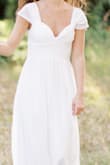 This dress was perfect for my COVID minimony! We got married with only our parents and grandparents and the dress was just dressy enough to be the bride but not overwhelmingly fancy or anything! I tacked the open shoulder sleeves up for personal preference but it was gorgeous with the sleeves down as well! I am 5'4" and the XS fit me in length well with my short heels! - Samantha C.