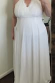 I read all the reviews and looked at all the review photos before purchasing this dress. I was looking for a flowy, sexy beach wedding dress. The dress is pretty, much heavier than I expected (very good quality!), and not even close to the low cut images I saw, which is one of the things I wanted. I felt matronly in the dress and will return it.
Again, very good quality and a bargain price, just not my dress. - Tina T.