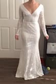 The dress does look similar to pictures, but it's very full coverage and and was too tight around my thighs. The cut of the back is cute, and I love the V cut in the front. - Madi S.