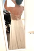 Beautiful dress but didn't look quite right on me. The model is tall with a small torso. The tie in the back makes the sizing more flexible. I was wearing a size 4 in this picture. Dress was very long. - Christine W.