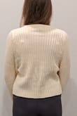 The shorter torso shows off a nice pair of high waisted jeans for a cold night out, but then I come home and switch to yoga pants and its still the perfect sweater. It is not white, definitely more of a cream color. The sleeves are a good length past the wrist, but if you do not like short sweaters, I would not recommend. - Andie F.