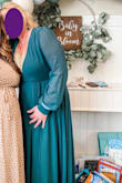 I chose to wear this dress for my daughters baby shower and received several compliments. Because it is a wrap dress, it is very forgiving for size adjustments. However, like a lot of other comments it is super low cut. As you can see in my photos, I have a gold sequin cami under mine. So plan for that. Other than that the dress is beautiful, and flows well. I like how the sleeves are sheer, but the rest of the dress is lined. The dress can be dressed up or down and worn for several occasions, I plan on wearing it again!! Give it a shot! - Kellie B.