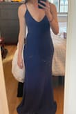 The fabric is quality and has good stretch, and the dress is long enough for 3" heels. It fits a little snug around my bottom (expected with a mermaid silhouette) but a little large on my chest. The adjustable straps help, but I don't like the bracket and extra fabric for adjusting the straps. This is easy enough to fix with a needle and thread, but there is still a little too much fabric. I have a rounded bottom, so unfortunately I don't think I can size down. - Lauren I.