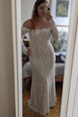 I got this dress as a backup in case my other option didn't get to me in time for my elopement - but it's strong enough to be the first choice, in my view! The silhouette is flattering; the lace is beautiful, especially the trim around the shoulders, and I'll echo other reviewers who say the photos don't do it justice. Yes, it's a bit tight in the arms so you won't be fist-pumping in this dress, but as far as making you feel like a princess - 100%. Wearing it with a 4-inch heel leaves almost no drag on the ground for the skirt. - Olesya S.