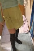 I like this skirt a lot. It's short, but not too short. It looks less green than online and more yellow. It goes with anything basically. Only downside is that it gets wrinkled easily. - Jessica H.