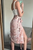 I love this wrap skirt, it is a very silky comfortable material and goes well with solid colored tops. I paired it with another Lulus item, the Symbolize White Sleeveless Bodysuit and white strappy heels from Amazon. I got multiple compliments on it and wore it out to a dinner and drinks at a nice restaurant. I'm a sucker for a good leg slit in a skirt or dress. If it's windy, just be cautious because the slit does open up to the top! I think it's the perfect combination of a sexy and classy night outfit. - Kellyn S.