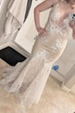 This dress is so much prettier in person than on the model. It has more of a train than shown. Probably because I'm short. It looks too loose on the model but fits me like a glove. The detail is so pretty. None of my friends guessed that I bought this online at this price  The quality is so good and the lace is so delicate. You won't be disappointed! - Danielle W.