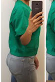 I love this green! The fit is loose which I'm not used to wearing, but I love the color and this color is hard to find. I would like the waist band to actually fit instead of being loose. It's pretty baggy altogether, but I think I can make it work. The material is very nice as well. I expected it to be thinner material, but it actually is a nice medium thick sweater material. The only thing is since it's so loose, I don't find it to give any warmth since it doesn't even touch my skin. That's what I don't get about these loose fitting sweaters! But it is nice and different so I'll likely keep it. - Jennifer W.