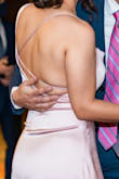 I love this dress! I read the reviews that said it runs large, so I got an XS (I'm usually a Small) and it did fit, but it was a bit tight, so I think Small would have been perfect for me. Either way, I loved it. The back is a show-stopper, it is my favorite part of the dress. 
I also read in the reviews that the sleeve falls down, but it was not the case for me, you just have to make the back string shorter. I used it for my engagement dinner and my fiancée and family loved it as well. - Teresa M.