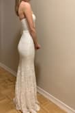 This dress is stunning. There are 2 light weight layers underneath and then the lace on top, giving it a high quality feel. The lace has a subtle sheen to it which looks amazing in person. I am about 95-98 lbs and I don't think it'll fit if I gain any weight. It does have some stretch to the lower portion of the dress but not so much in the bust. I'm 5'0 and wearing 2 inch heels in the pics. The back is high enough that I can wear a strapless bra. I've had the worst time finding mermaid dresses that fit a petite frame and I literally couldn't have asked for a better fit with this dress! - Erin S.