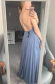 I love it! Bought for a friends wedding coming up in July. The back straps are adjustable making it sit how you would like. The dress is long, but that's to be expected as it has to fit a wide variety of heights! I will be getting mine altered to take off a few inches, which I planned on doing before buying. The price and quality are great. It's not see through, and it's very flowy which is super fun. Keep in mind you have to wear sticky boobs or go braless. (Worth it!) - Nicole H.