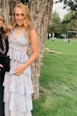 I bought this dress for my daughter to wear to an outdoor wedding.. it's a gorgeous dress. It is a deep V neckline, but fashion tape kept in it place. It was true to size. - Gael C.