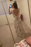 I ordered this dress for my bridal shower and I'm super excited to wear it! It is super long though. It barely hits the floor while I wear 4 inch heels. I also tightened the straps as much as possible. Other than the length, it fits true to size! It's a nice material too. My only complaint is that the material on the neckline doesn't lay right. I'm not sure if it's me or the dress though because it doesn't lay like that on the hanger. Overall, I'd recommend this dress. I think a little bit of body/clothing tape will hold it in place! - Lindsay S.