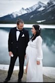 Loved this dress for my elopement! I ordered a medium in hopes that it would fit my little boobies, but also accommodate my 8 month pregnant belly. It fit almost perfectly! I did end up having to take the breast part in just a bit, but the sleeves were a perfect length, and the overall fit was amazing. Also super loved the material! I got married in the mountains in Canada and it was quite cold, but the dress kept me surprisingly warm (at least warmer than if I had worn a strapless dress). Great quality fabric. Love love love this dress. - Danika H.