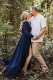 I bought this dress in the blue for engagement photos, I originally ordered a M, however the front did not have enough coverage when wrapped so I went to a large. The dress is definitely long and had I wore it to an event it would have needed to be hemmed. I wore this with a Wedge sandal for engagement photos and received a lot of compliments. Super comfortable, flattering, and fun. - Danielle A.