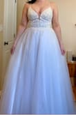 I had hoped this dress would be "the one" but unfortunately I have to return it. I ordered both this and the True Love dress in size 6 and ultimately decided on True Love (I'm eloping and that dress works better). I ordered size 6 with the help of a sales associate. The beaded bodice was far too tight. I almost didn't get it zipped all the way up. It has very beautiful intricate beading which I loved. The tulle skirt poufed out like a ball gown and if the top wasn't so tight, I imagine it would look quite lovely. It's VERY glittery. My fiancé asked why there was glitter all over our floor... it looks pretty though and would photograph nicely. Overall, a super beautiful dress. I possibly would've kept it if I had ordered the correct size. I would advise to size up and then have it tailored to you!! - Kaitlin S.