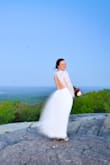 This dress was PERFECT for my mountaintop elopement. I have a very small chest and narrow shoulders, so I had the top altered so the sleeves and bust were tighter. Had to shorten as well, but that was to be expected because I am short :) The dress is SUCH beautiful quality, especially for the price. The lace is beautiful and the deep v front is really flattering. Waist doesn't have any stretch, so order your true size. Small was perfect for me. - Kate E.
