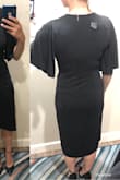 I usually am a true medium in Lulus, but I sized down based on reading the other reviews. I recommend sizing down! I am pretty busty so I usually can't size down unless the fabric is stretchy. This one is stretchy! The lining goes almost down to my knees and the cross over is flattering. I could probably have sized down again if I didn't need the lining as low, but this is for a funeral so I will stick with the longer length. Only reason for not putting 5 stars is that I think the cut could be a little more flattering, but I am still happy to keep this and if they sold other colors I would still get those too - Jess F.