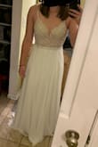 This dress is absolutely beautiful, but ended up not being my style. To me, it felt too prommy, but the fabric was beautiful and beading secure. The cups were a bit too large for my small chest, but it photographed well! One note: prepare to hem the skirt - there's a lot of material there! - Laura S.