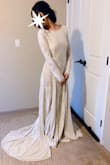 This dress looks very similar to my dream wedding dress I had wanted for years that is now worth around 3000. I was hesitant to try on the Lulus version but decided to just go for it. Unfortunately they did not have my size (XS) so I went for a small. This dress is extraordinary. The way the dress hugs your body and the train is absolutely gorgeous. The mixture of material gives the train of this dress a beautiful flow, I felt like a princess! This dress and its detail is so much more beautiful in person. The reasons why I did not choose this as my dress was because it wasn't my size (though the small still fit well), there is also quite a bit of material to this dress, so it feels slightly bottom heavy (great quality, feels amazing but wouldn't work for my wedding situation). If you are debating whether or not to try this dress on, do it!! It is so beautiful, you won't regret it! - Kayla L.