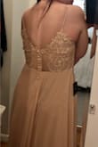 This dress is so pretty. The detail on the back is gorgeous, but you definitely cannot wear a bra with it. If you have a smaller chest or naturally higher-sitting breasts, you will probably be ok. I definitely need lift and support though and this dress does not have it. The material on the chest is also not very thick, so people will probably know if you're chilly. The color is pretty, but definitely more nude than pink, so I did feel a little washed out in it. - Jillian G.