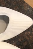 These shoes are actually really comfortable since there's no back to them and since it's knit material. They stay on nicely and look so fancy from how white they are. Perfect fit! - Melanie H.