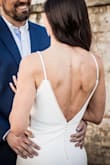 My husband and I recently did a photoshoot for our 15th wedding anniversary. I no longer have my original wedding dress, so I tried the Taliana in hopes that I wouldn't have to spend a lot. This dress is gorgeous. The fabric is thick (can't see undergarments) and stretchy for a beautiful hugging fit. I wore a sticky bra underneath, but petals would work well, too. I am 5'10" and wore converse and it just barely touched the ground. Definitely couldn't have worn heels for the look I was going for but if you are 5'8 or shorter it would probably be great with heels. I figured I would turn around and resell it after the photoshoot but I loved it more than my actual wedding dress and can't part with it! It's so well made and so comfortable. - Ashley W.